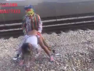 Clown fucks young female on train tracks